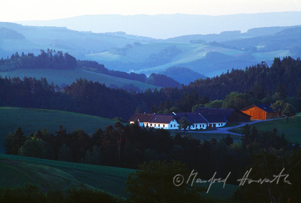 Bauernhof in hügeliger Landschaft
