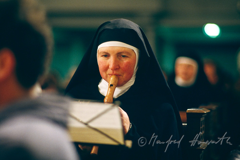 Nonne spielt Flöte in der Kirche