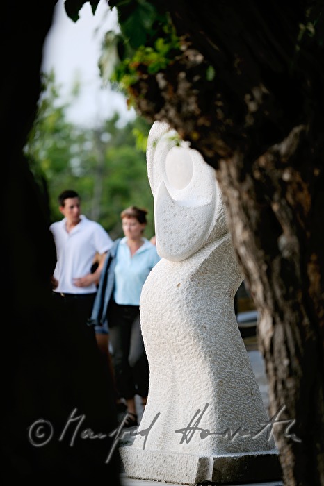 Stein-Skulptur und Spaziergänger
