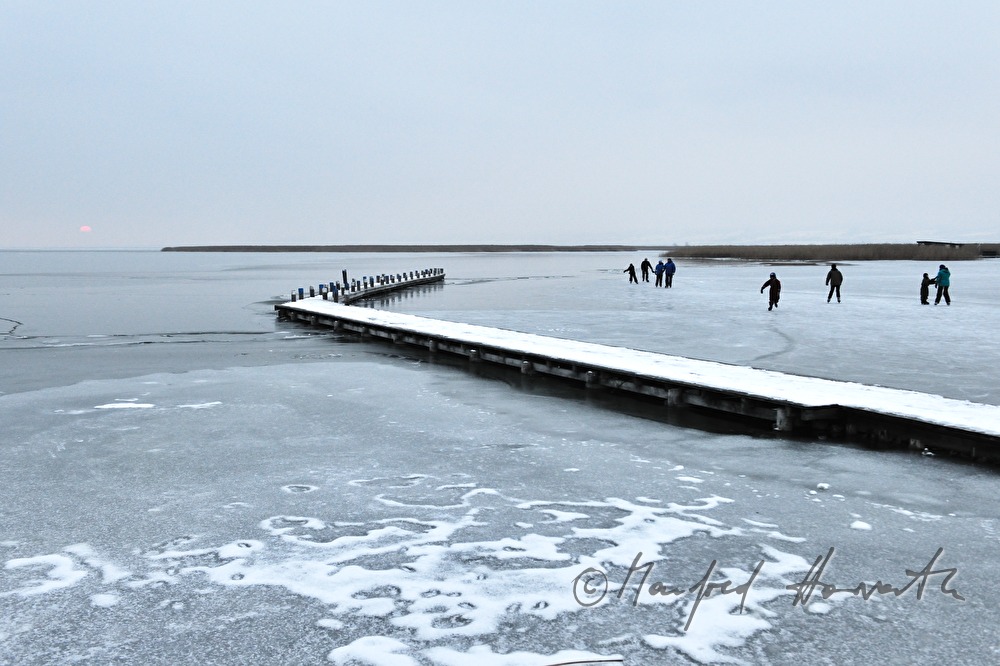 Steg und Eisläufer bei Sonnenuntergang