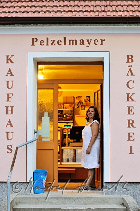 Verkäuferin vor ihrer Greisslerei