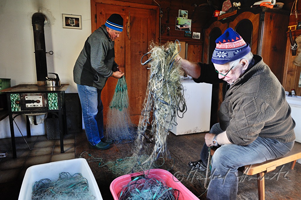 Fischer reparieren das Netz in der Lechhütte