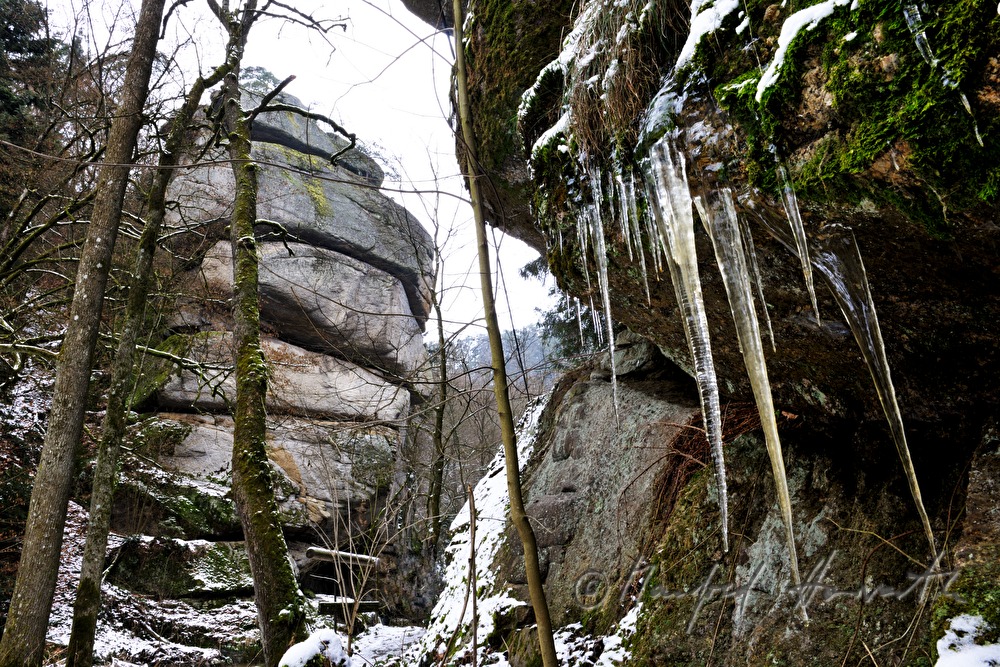 moosbedeckter Felsen und zerklüfteter Granit