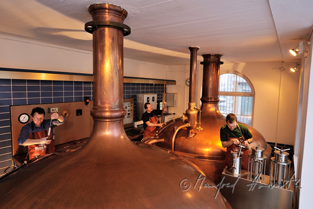 Braumeister und Arbeiter brauen Bier im Sudhaus