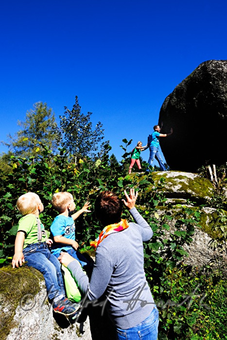 Familie versucht den Granitblock zu bewegen