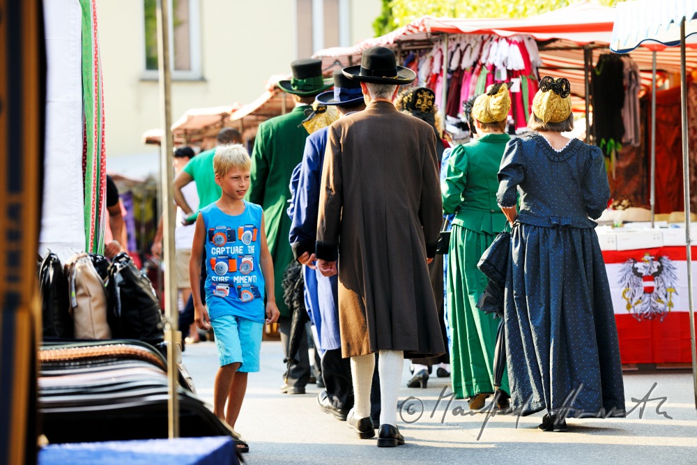 Gruppe von Mostviertlern in Tracht am Jahrmarkt